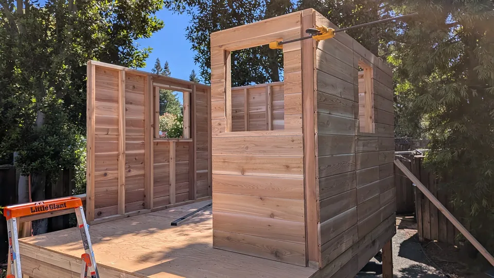 Wall panels being assembled for the May 2026 raised playhouse